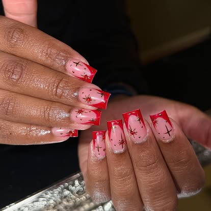 Red French-tip set with black star nail art